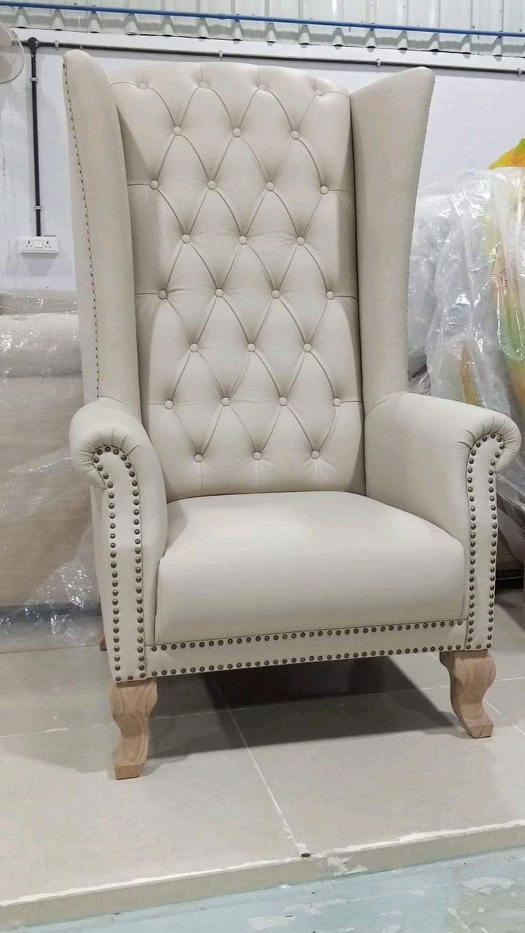 Ivory tufted high-back wingback chair with wood legs