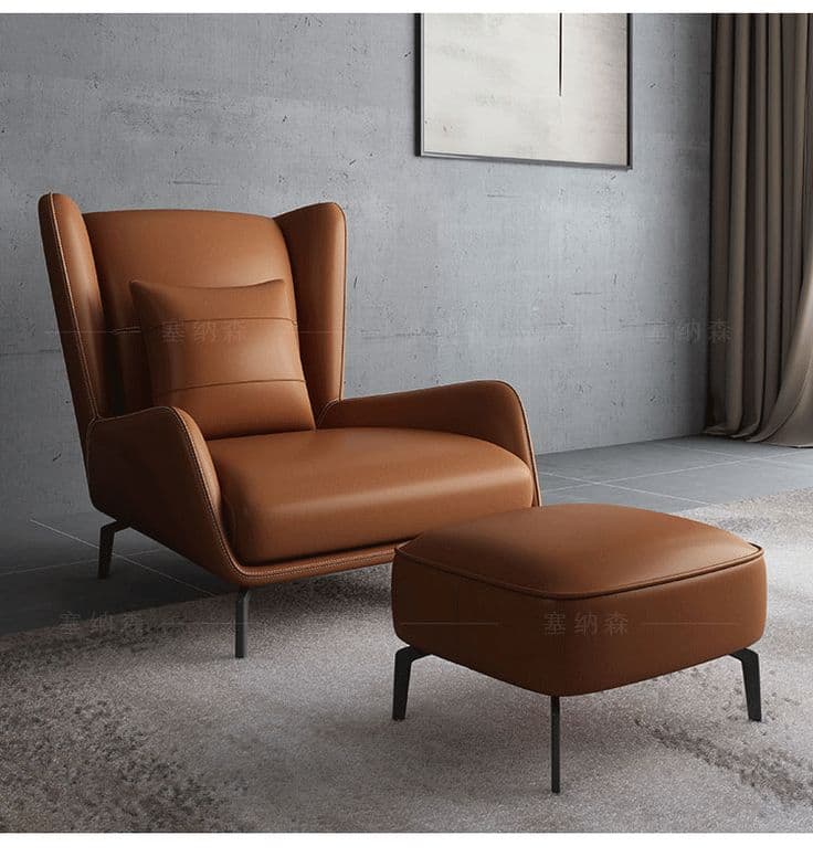 Rust leather wingback chair with matching ottoman