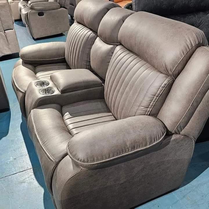 Brown leather corner sofa with round ottoman