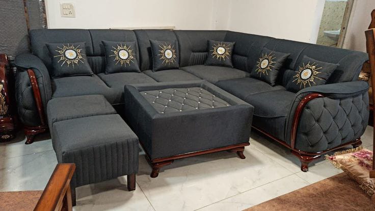 Charcoal grey corner sofa set with polished wood trim and ottomans