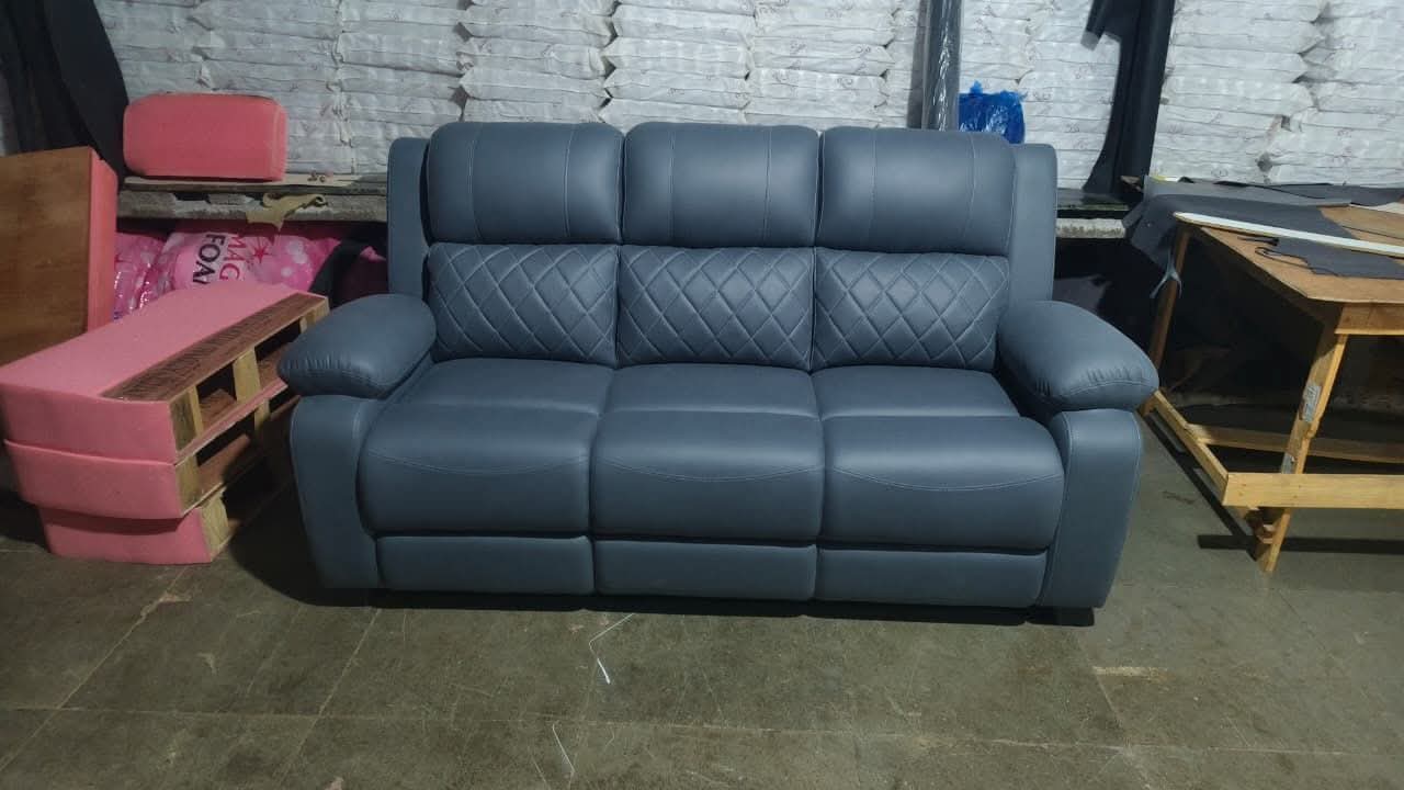 Navy blue quilted leather reclining loveseat