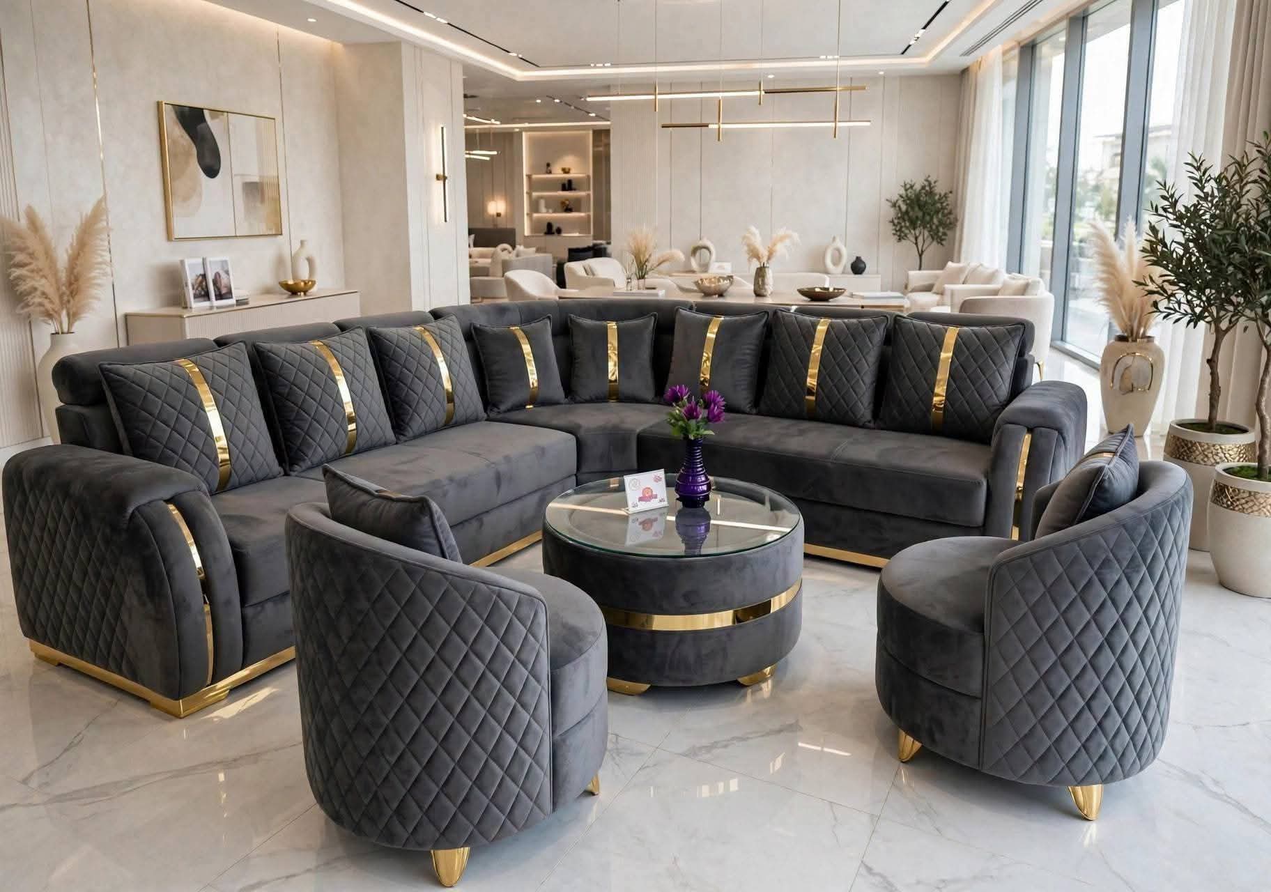Charcoal velvet U-shaped sofa set with gold trim in a luxury living room