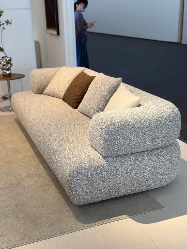 Stone grey boucle sofa with bolster cushions