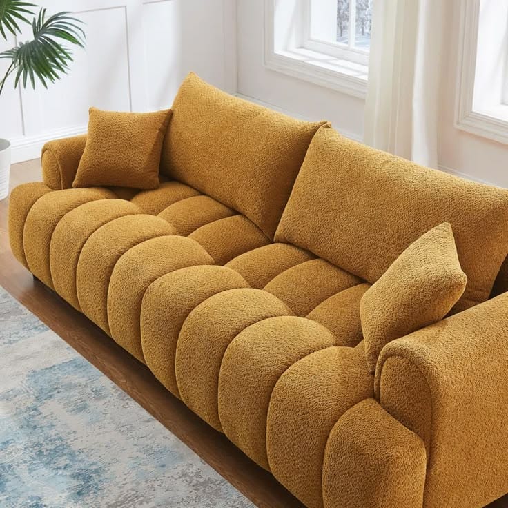 Mustard yellow channel-tufted boucle sofa