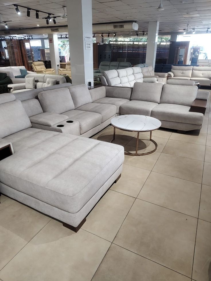 Light grey U-shaped sectional sofa with chaise in showroom